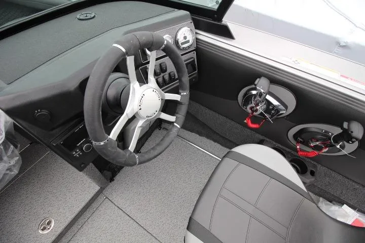 Slide: The Image of 2026 Lund 2075 Tyee boat interior with steering wheel and control panel. - 4