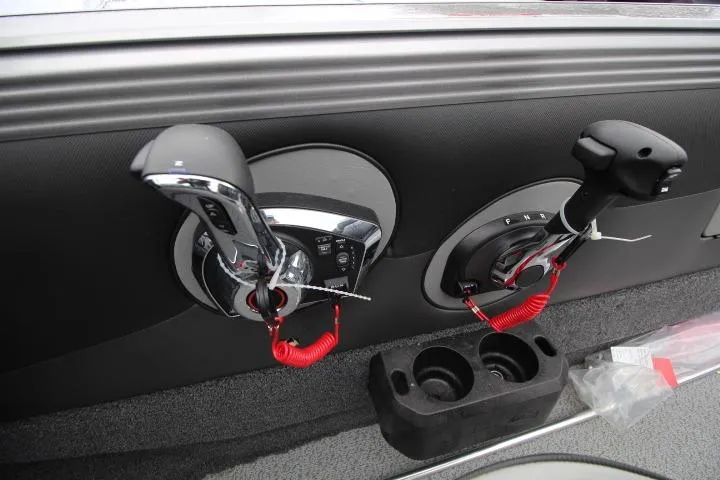 Slide: The Image of 2026 Lund 2075 Tyee boat controls with dual throttle levers and cup holders. - 6