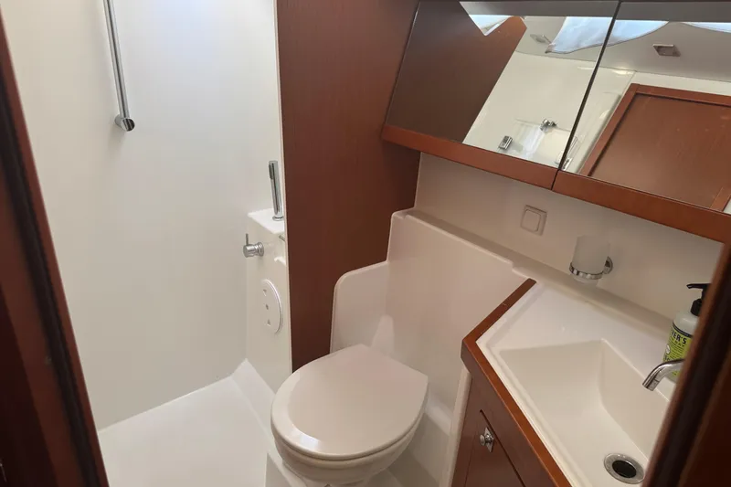 Slide: The Image of Bathroom interior of 2015 Beneteau Oceanis 48 yacht, featuring toilet and sink. - 10