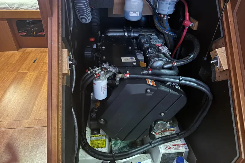 Slide: The Image of Engine compartment of a 2015 Beneteau Oceanis 48 sailboat, showcasing mechanical components. - 14