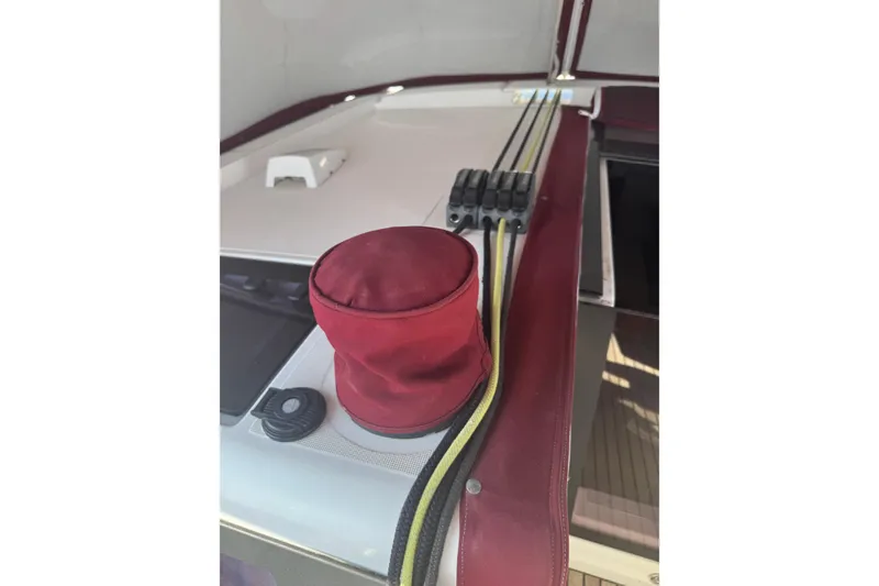 Slide: The Image of Beneteau Oceanis 48 (2015) deck with red winch cover and rope clutches. - 15