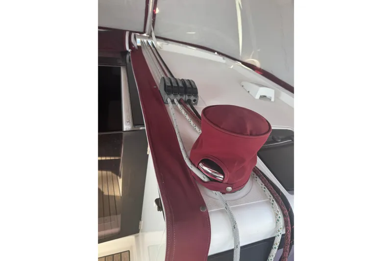 Slide: The Image of Beneteau Oceanis 48 (2015) deck detail with maroon sail cover and rigging. - 16