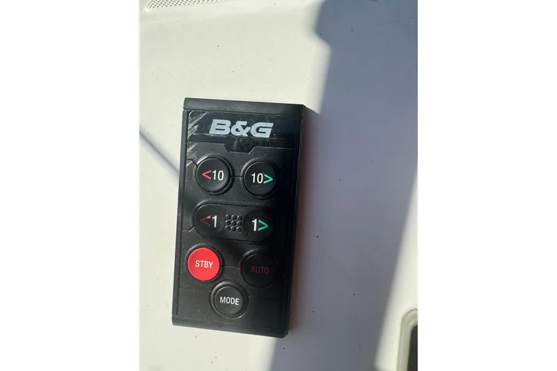 Slide: The Image of B&G remote control on Beneteau Oceanis 48 yacht, 2015 model, featuring navigation buttons. - 19
