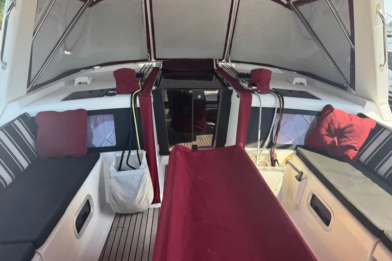 Slide: The Image of Interior of 2015 Beneteau Oceanis 48 sailboat with red and black seating. - 22