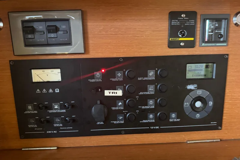 Slide: The Image of Control panel of a 2015 Beneteau Oceanis 48 yacht, featuring various switches and gauges. - 5