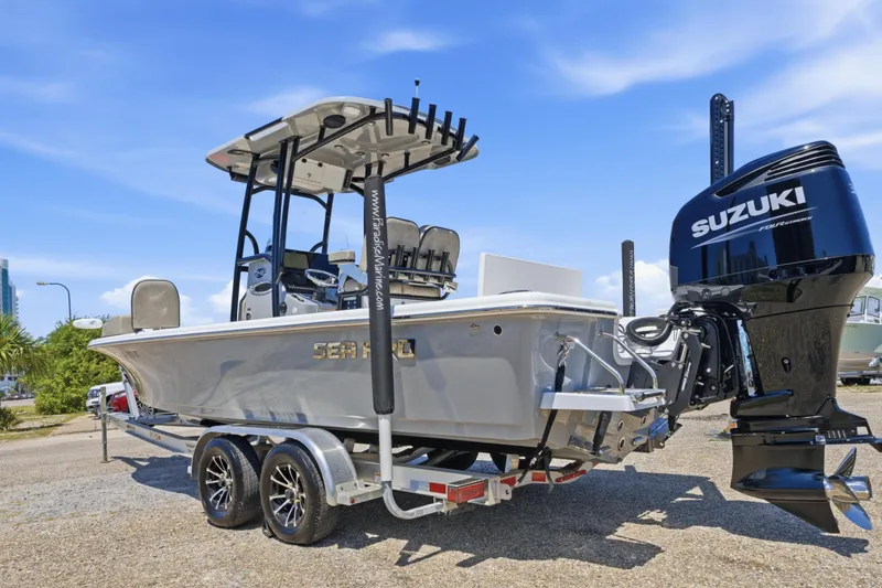 Slide: The Image of 2023 Sea Pro 248 Bay boat with Suzuki engine on trailer, parked outdoors. - 11
