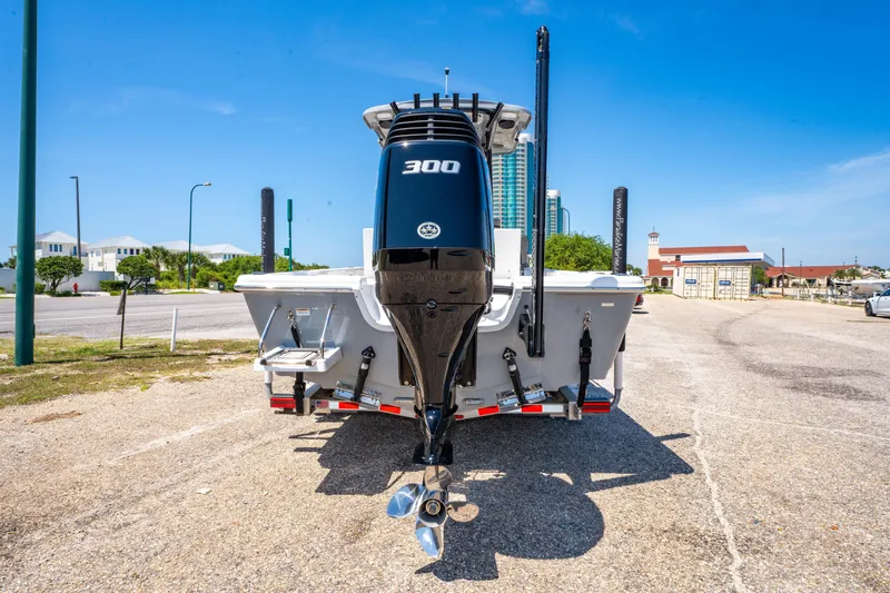 Slide: The Image of 2023 Sea Pro 248 Bay boat with powerful 300 horsepower engine, parked on sunny day. - 12