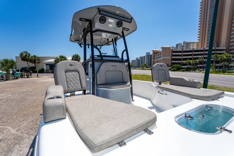 Slide: The Image of 2023 Sea Pro 248 Bay boat with cushioned seating and modern design in urban setting. - 17