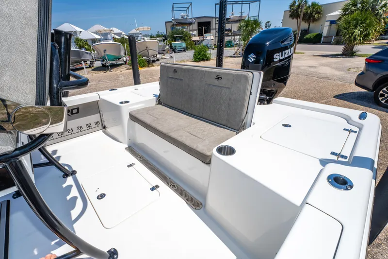 Slide: The Image of 2023 Sea Pro 248 Bay boat interior with seating and Suzuki engine. - 19