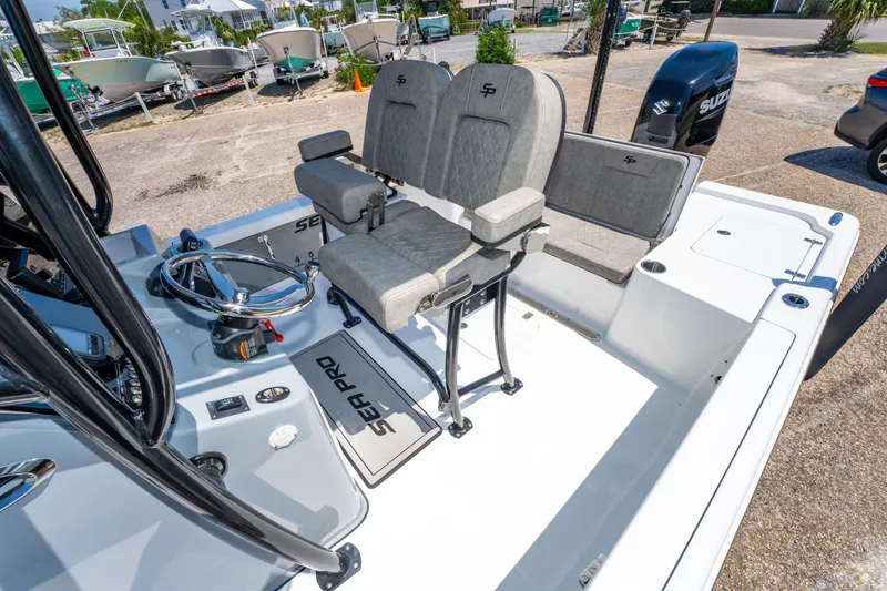 Slide: The Image of 2023 Sea Pro 248 Bay boat interior with dual seats and steering console. - 20