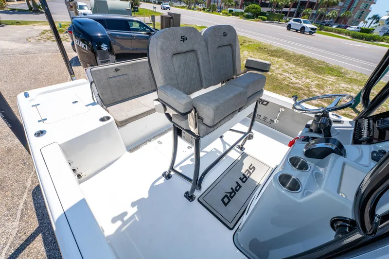 Slide: The Image of 2023 Sea Pro 248 Bay boat interior with dual seats and steering console. - 21