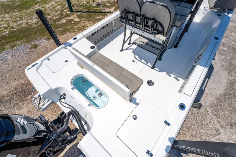 Slide: The Image of 2023 Sea Pro 248 Bay boat interior with seating and storage compartments. - 22