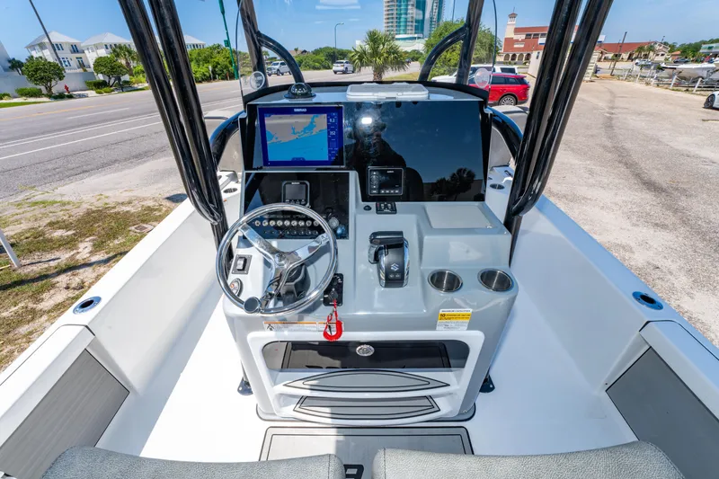 Slide: The Image of 2023 Sea Pro 248 Bay boat dashboard with steering wheel and navigation display. - 25