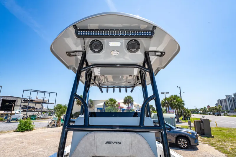 Slide: The Image of 2023 Sea Pro 248 Bay boat with T-top and speakers, parked outdoors. - 31