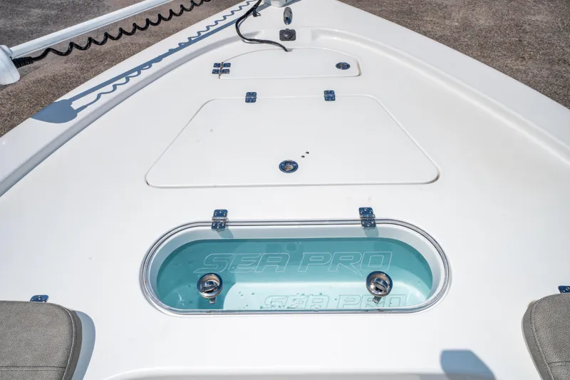 Slide: The Image of 2023 Sea Pro 248 Bay boat deck with storage compartments and livewell. - 32