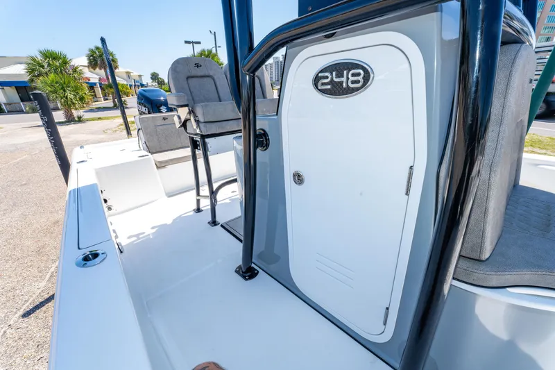 Slide: The Image of 2023 Sea Pro 248 Bay boat interior with seating and storage compartment. - 35