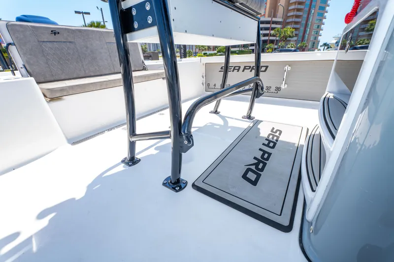 Slide: The Image of 2023 Sea Pro 248 Bay boat interior with seating and branded mat. - 37