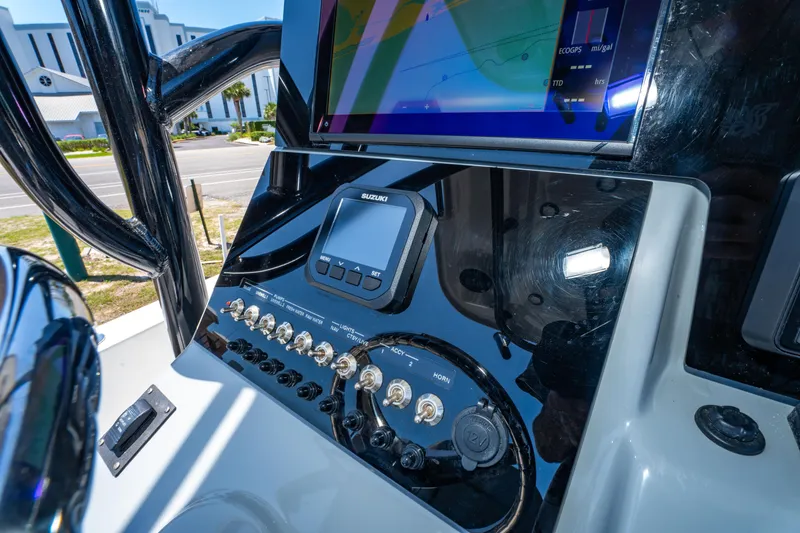 Slide: The Image of 2023 Sea Pro 248 Bay boat dashboard with navigation controls and display screen. - 39