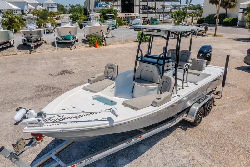 Slide: The Image of 2023 Sea Pro 248 Bay boat on trailer, parked in marina lot. - 4