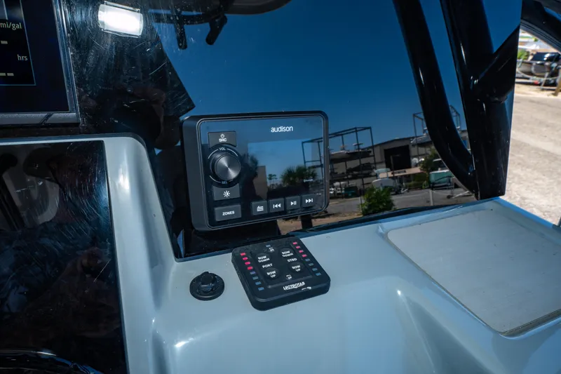 Slide: The Image of 2023 Sea Pro 248 Bay boat dashboard featuring Audison audio controls and electronic panel. - 40