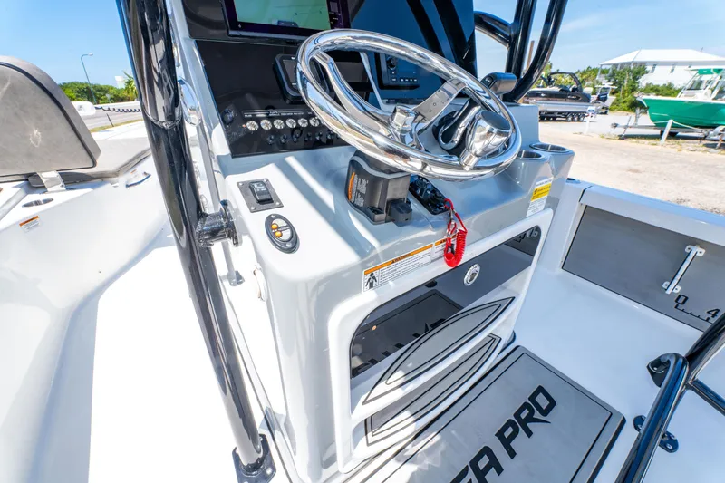 Slide: The Image of 2023 Sea Pro 248 Bay boat console with steering wheel and control panel. - 41