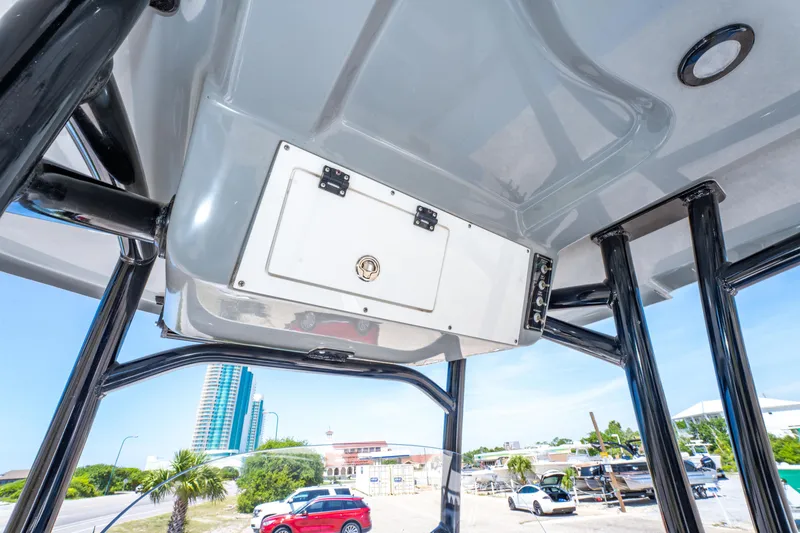 Slide: The Image of 2023 Sea Pro 248 Bay boat T-top with storage compartment and urban background. - 42