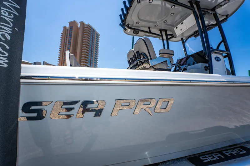 Slide: The Image of 2023 Sea Pro 248 Bay boat with tower, cityscape background. - 46