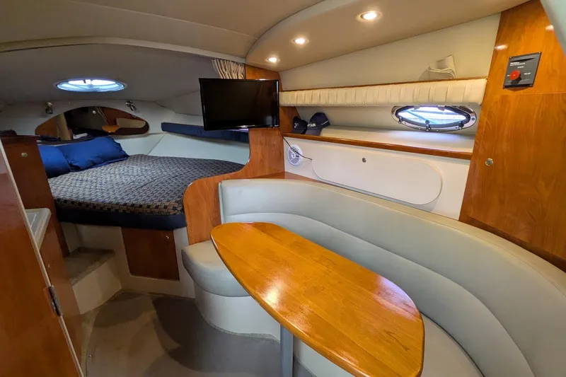 Slide: The Image of Interior of 2005 Cruisers Yachts 280 CXi Express with cozy seating and sleeping area. - 2