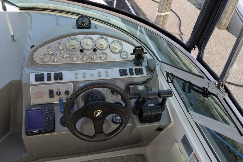 Slide: The Image of 2005 Cruisers Yachts 280 CXi Express helm with gauges, steering wheel, and controls. - 5