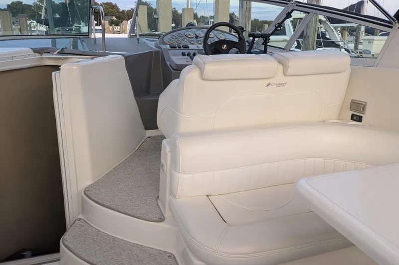 Slide: The Image of 2005 Cruisers Yachts 280 CXi Express interior with white seating and helm. - 7