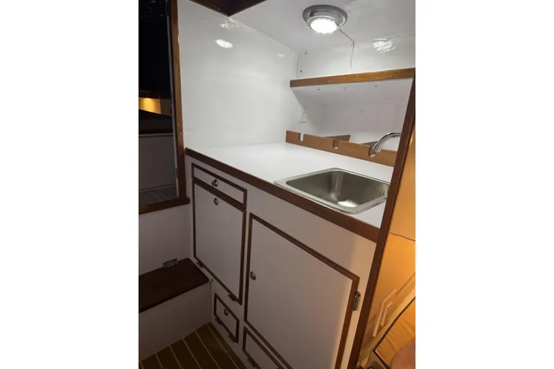 Slide: The Image of 1973 Dyer 29 Bass Boat interior with sink and storage cabinets. - 10