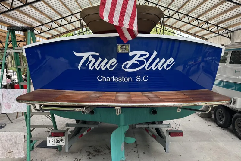 Slide: The Image of 1973 Dyer 29 Bass Boat "True Blue" in Charleston, S.C., under a metal roof. - 11
