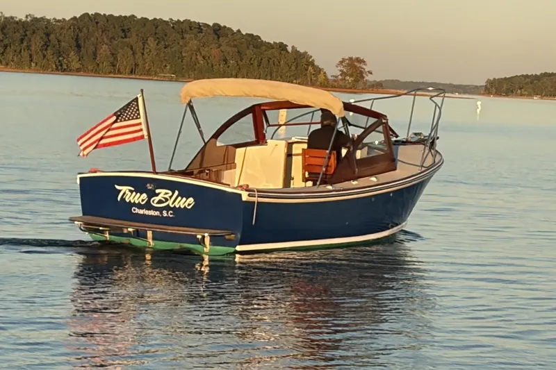 Slide: The Image of 1973 Dyer 29 Bass Boat "True Blue" on calm water, Charleston, S.C., with American flag. - 3