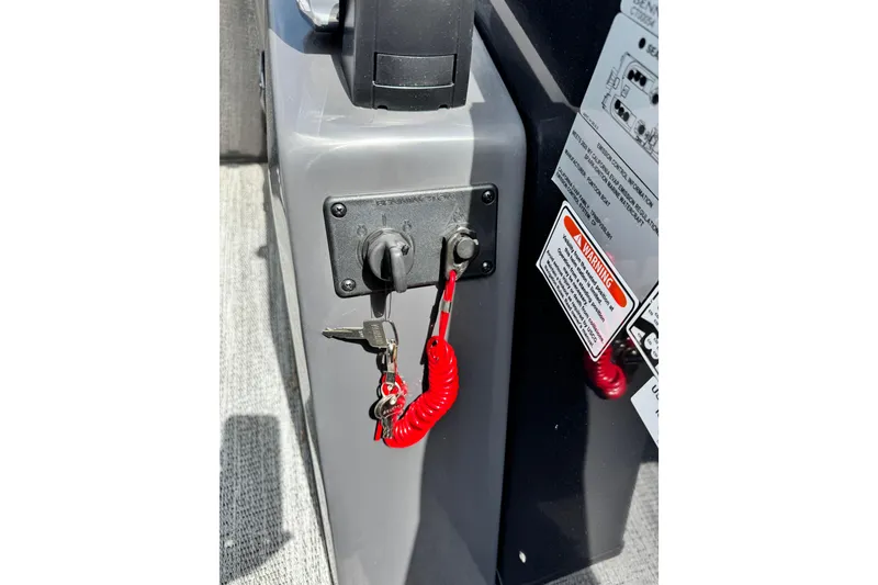 Slide: The Image of 2026 Bennington S 23 SSR ignition panel with keys and safety lanyard. - 11