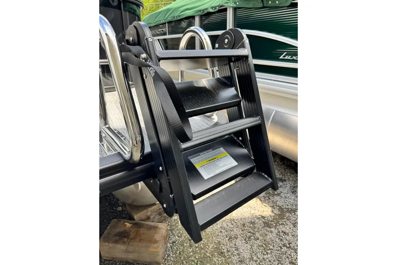 Slide: The Image of Bennington 23 boat ladder, 2026 model, with sturdy black steps and chrome handles. - 6
