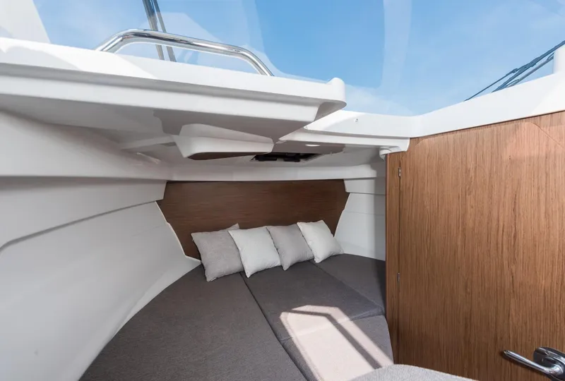 Slide: The Image of 2024 Beneteau Antarès 7 cabin interior with cozy bedding and wooden accents. - 18