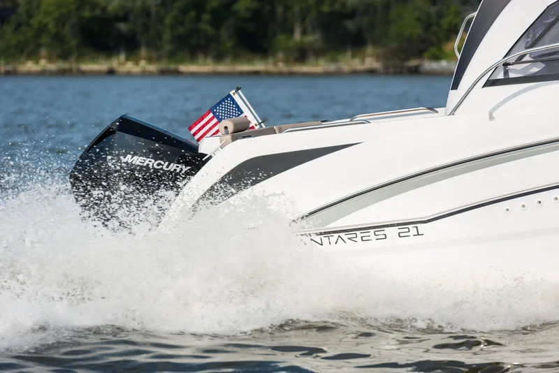 Slide: The Image of 2024 Beneteau Antarès 7 boat cruising with Mercury engine on a lake. - 2