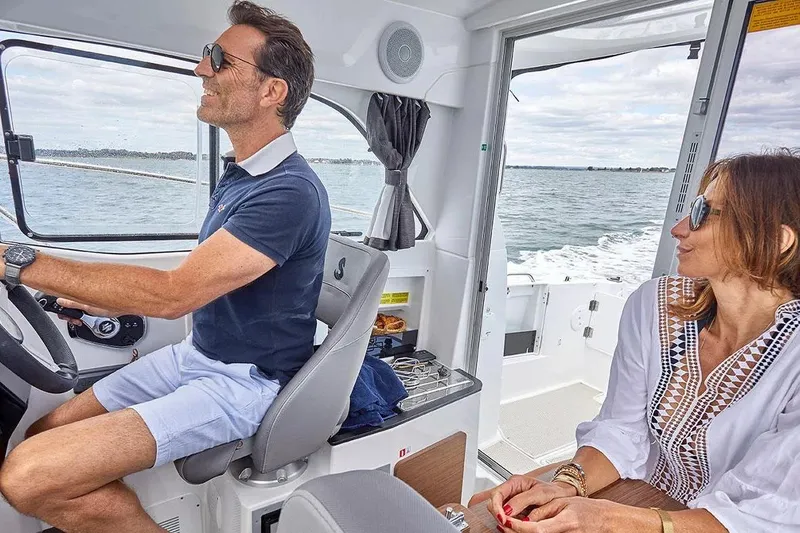 Slide: The Image of Couple enjoying boat ride on Beneteau Antares 7, 2026 model. - 11