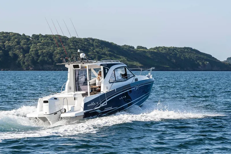Slide: The Image of Beneteau Antares 7 2026 cruising on water, coastal landscape in background. - 5