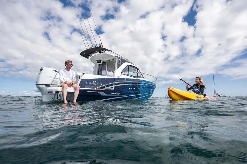 Slide: The Image of Beneteau Antares 7 boat and kayaker on the sea, 2026 model. - 6