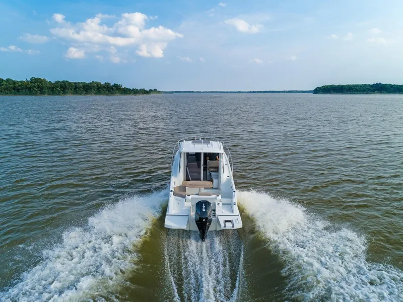 Slide: The Image of 2024 Beneteau Antarès 7 motorboat cruising on a lake. - 7