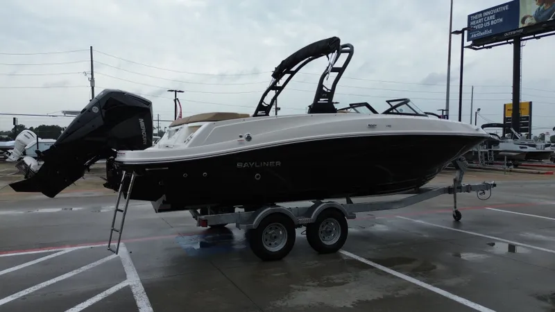Slide: The Image of 2026 Bayliner VR6OB boat on trailer parked outdoors. - 10