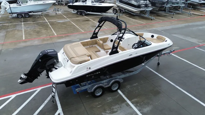Slide: The Image of 2026 Bayliner VR6OB boat parked on trailer outdoors. - 11