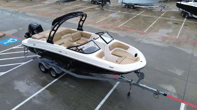 Slide: The Image of 2026 Bayliner VR6OB boat parked on trailer outdoors. - 13