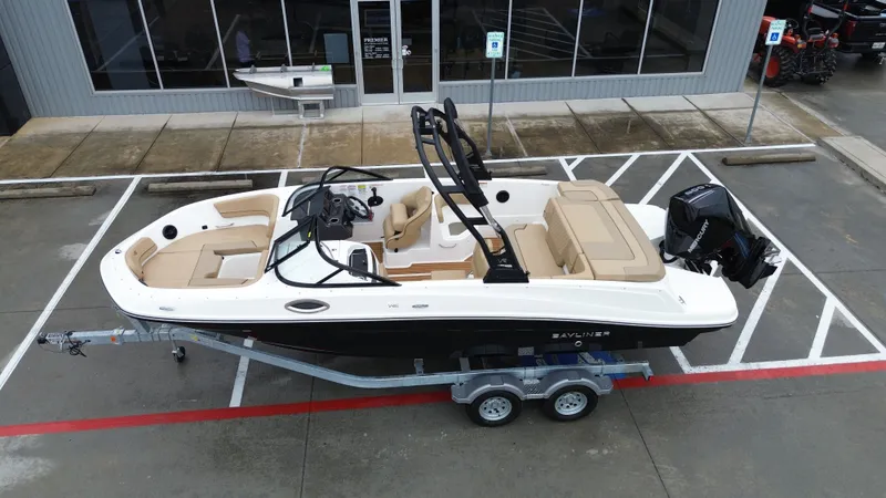 Slide: The Image of 2026 Bayliner VR6OB boat on trailer in front of building. - 16