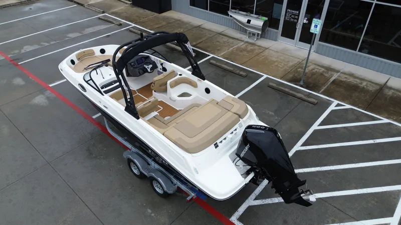 Slide: The Image of 2026 Bayliner VR6OB boat parked on trailer outdoors. - 17