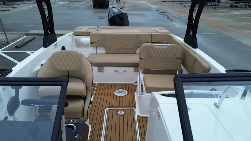 Slide: The Image of Interior of 2026 Bayliner VR6OB with beige seating and wood flooring. - 22
