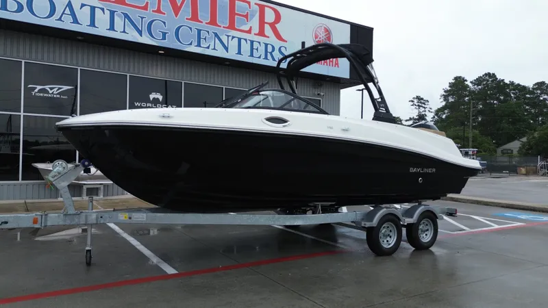 Slide: The Image of 2026 Bayliner VR6OB boat on trailer outside a boating center. - 5