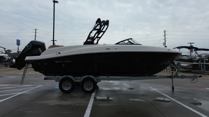 Slide: The Image of 2026 Bayliner VR6OB boat parked on trailer outdoors. - 7