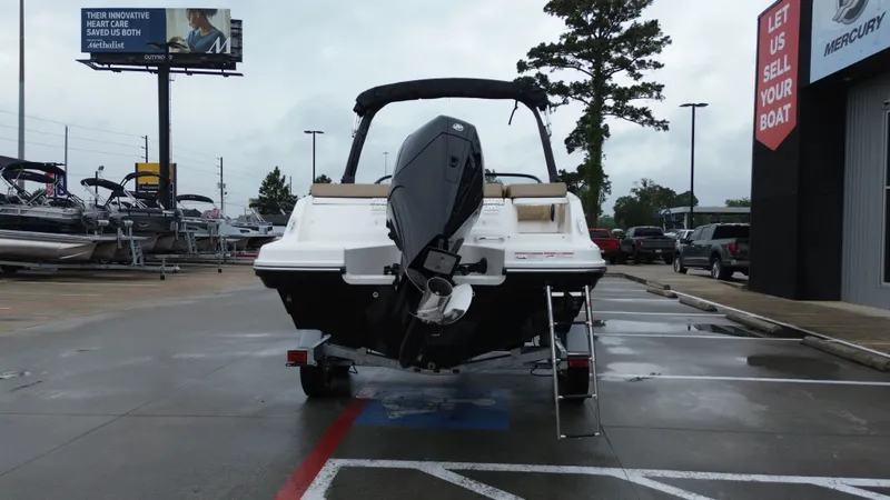 Slide: The Image of Rear view of a 2026 Bayliner VR6OB boat in a parking lot. - 9